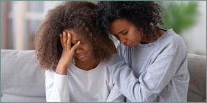 woman consoling another woman